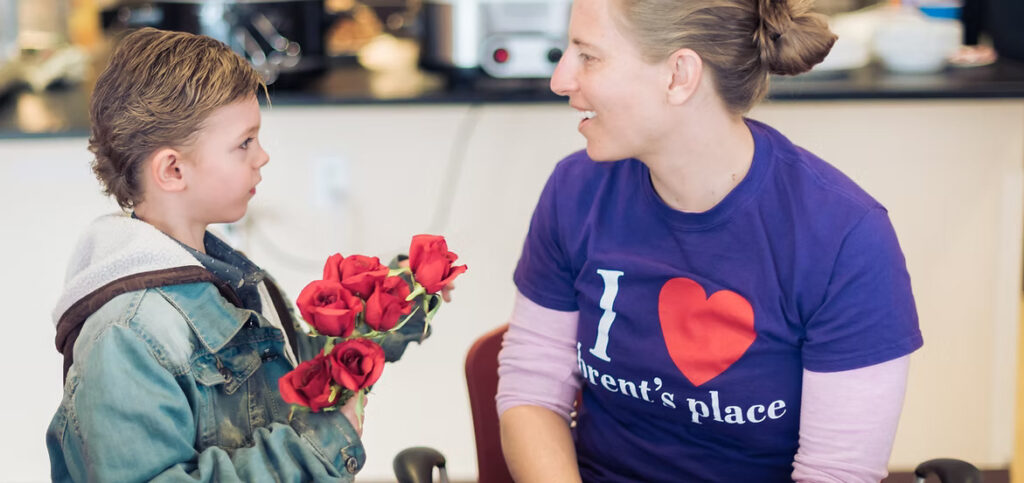 Brent's Place Volunteer and a child holding roses