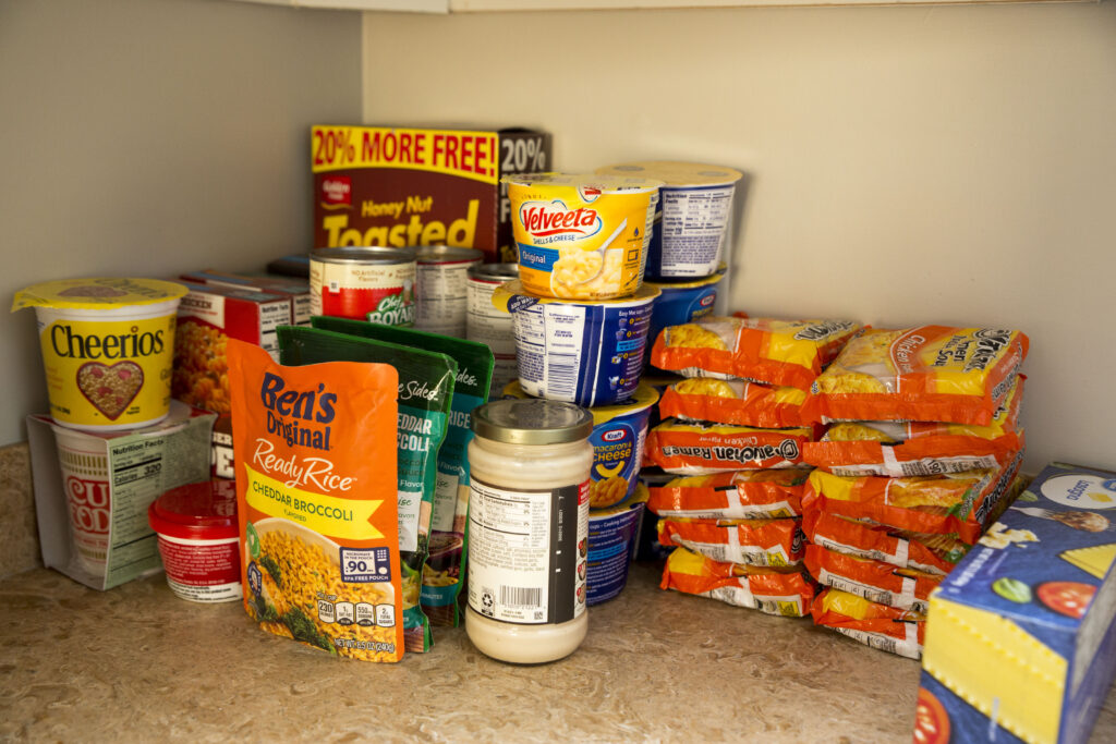 Dried goods and other groceries stacked neatly on kitchen countertop.